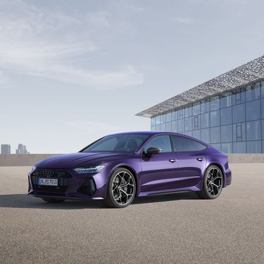 Side rear view of the R8 Coupé V10 performance RWD in purple in front of a wall of metal panels