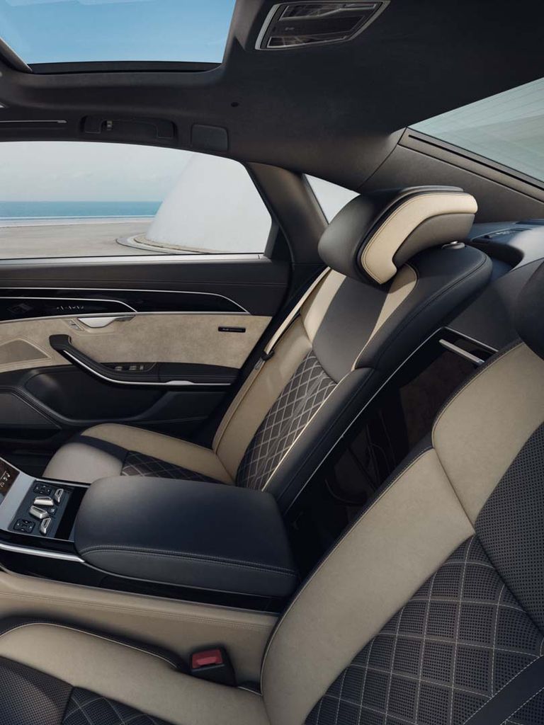 Side view of the rear seats of the A8 L with brown full leather upholstery and contrast stitching