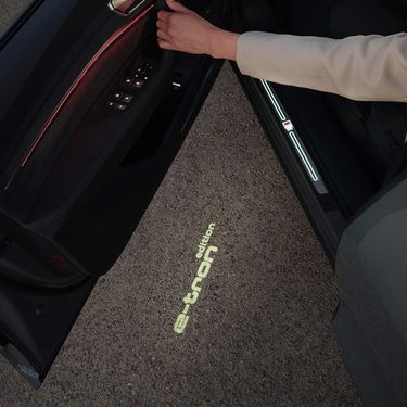 Opened driver&#39;s door with floor light projection Audi Q8 e-tron